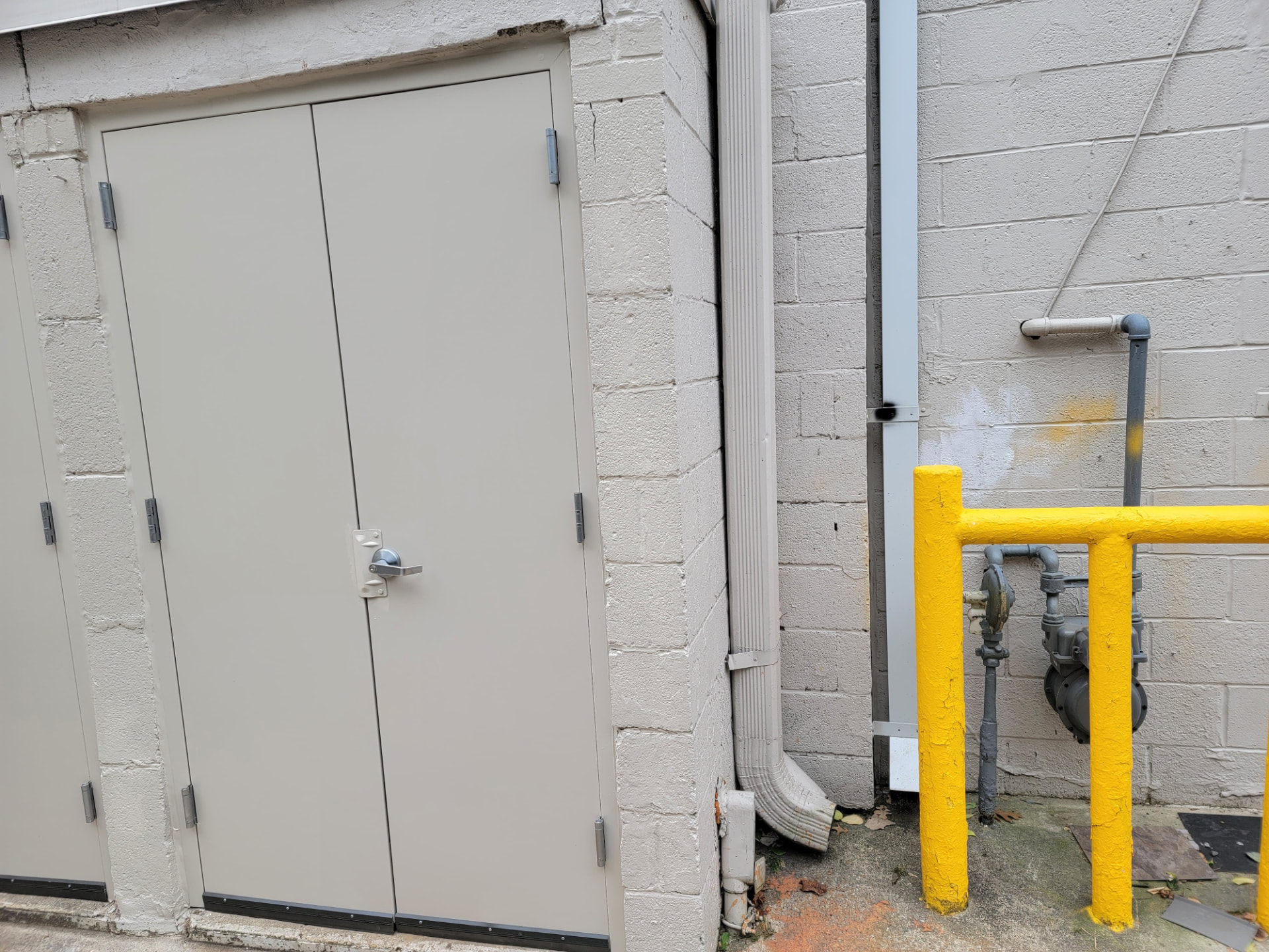 After — Commercial utility room — rotted frame rebuilt, new steel doors