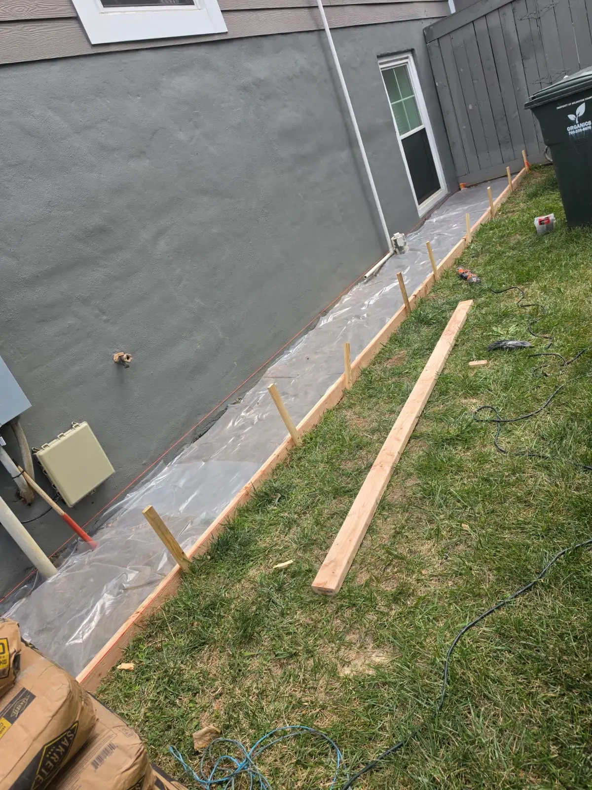 Before — Side walkway — forms and reinforcement set, concrete poured and finished