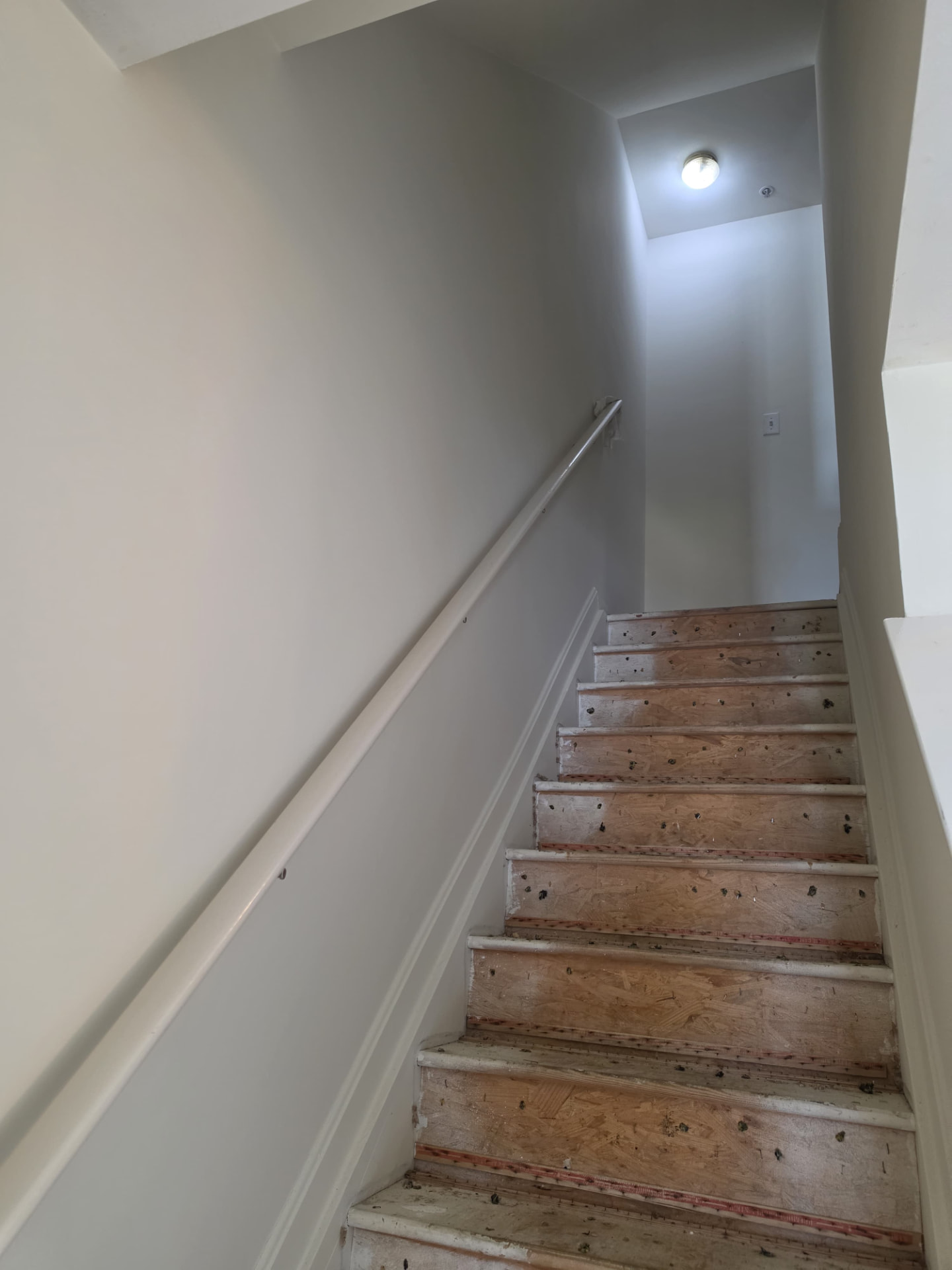 Before — Stairway remodel — walls and trim repainted, new carpet installed
