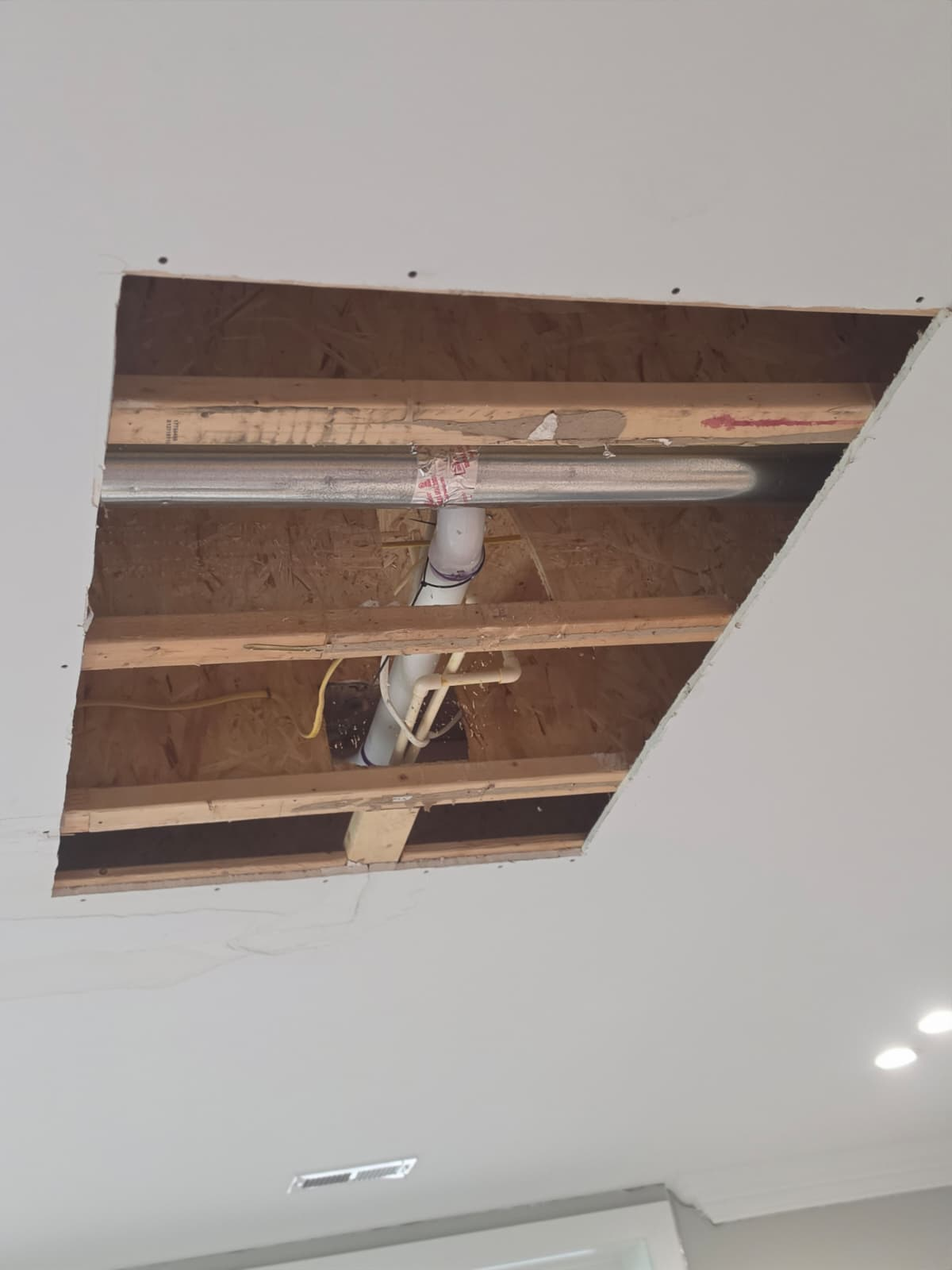 Ceiling drywall opened for access before patching — Real AJN Handyman LLC project