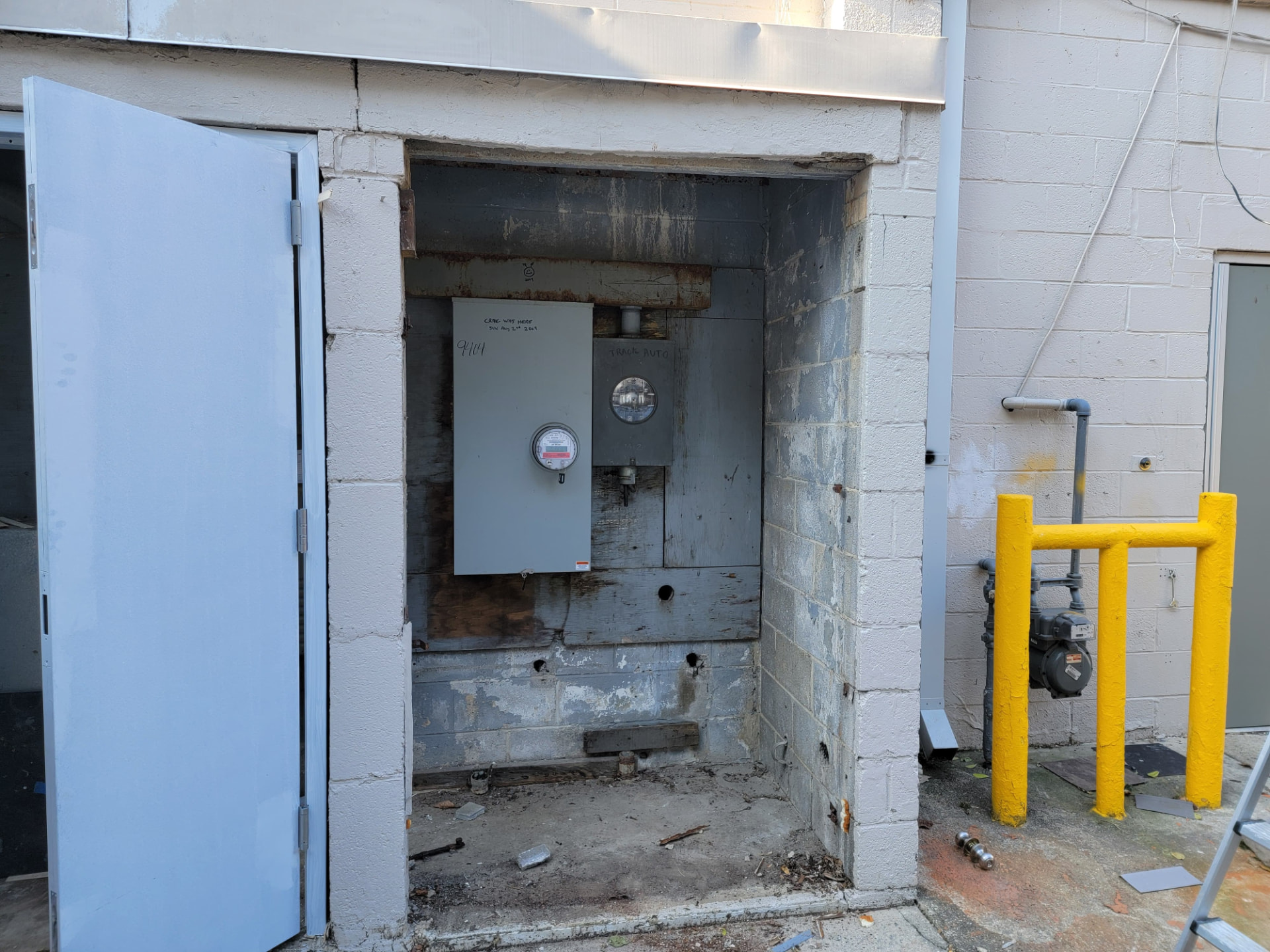 Before — Commercial utility room — rotted frame rebuilt, new steel doors