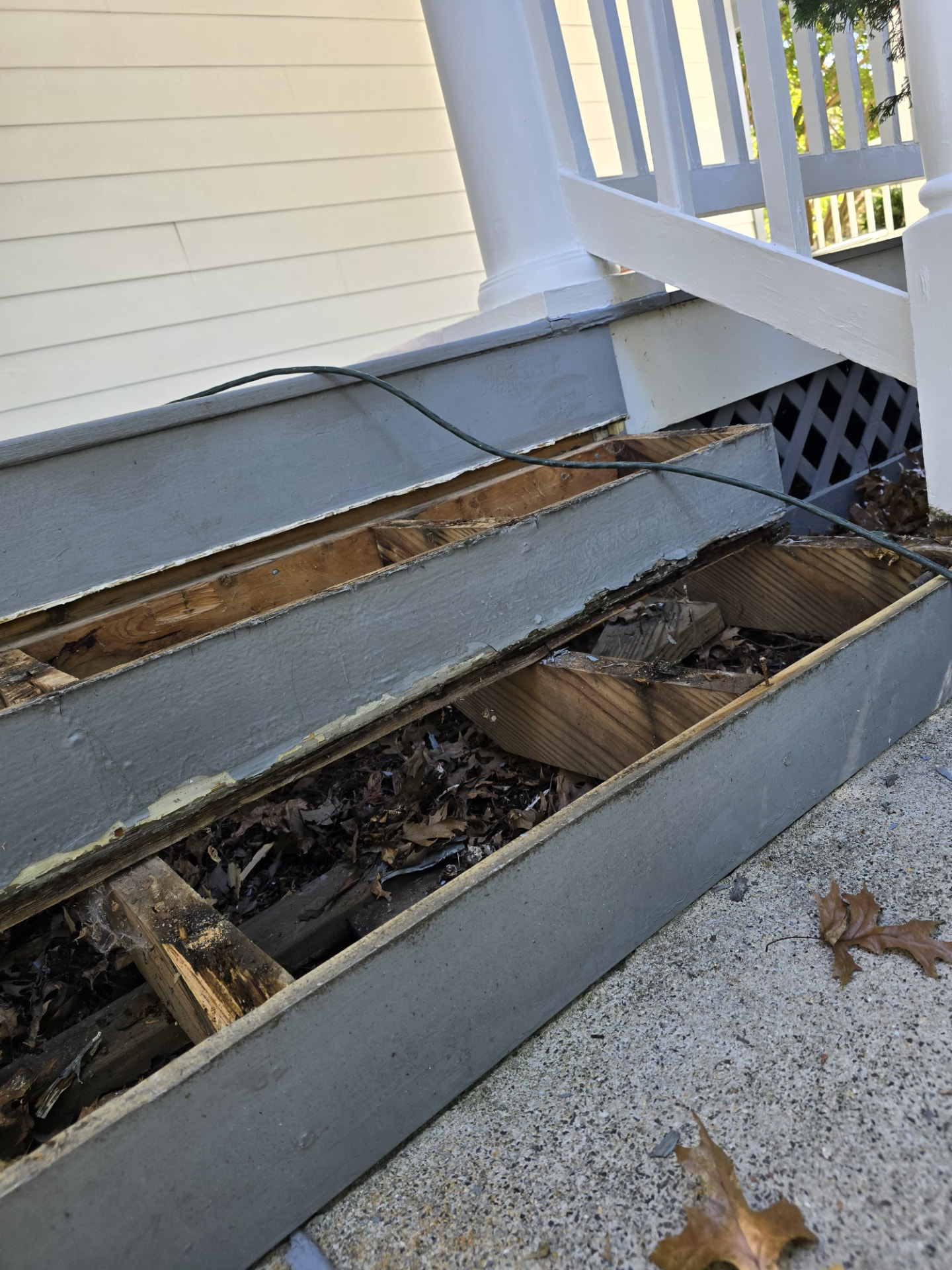 Before — Front porch — rotted steps and skirting rebuilt, lattice replaced